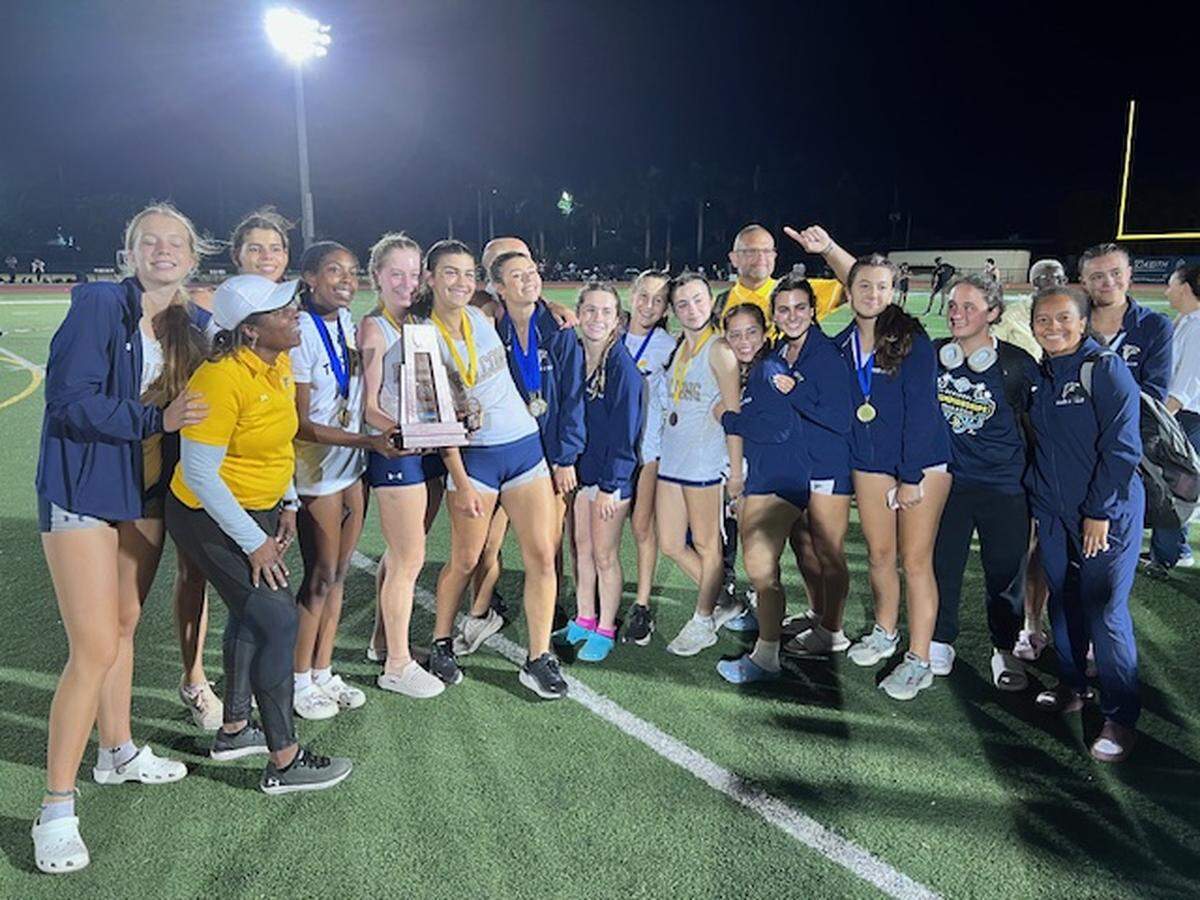 The Palmer Trinity girls’ track and field team celebrates after winning the Region 4-1A championship at Calvary Christian on Tuesday.