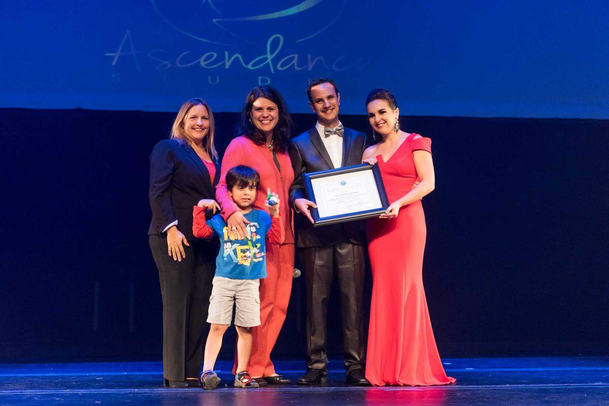 Doral Councilwoman Claudia Mariaca and Doral Vice Mayor Ana Maria Rodriguez, with son Eros Canabal, on June 10 present a framed certificate from the city to Ascendance Studio co-owners Rafael Savino and Valentina Bagala.