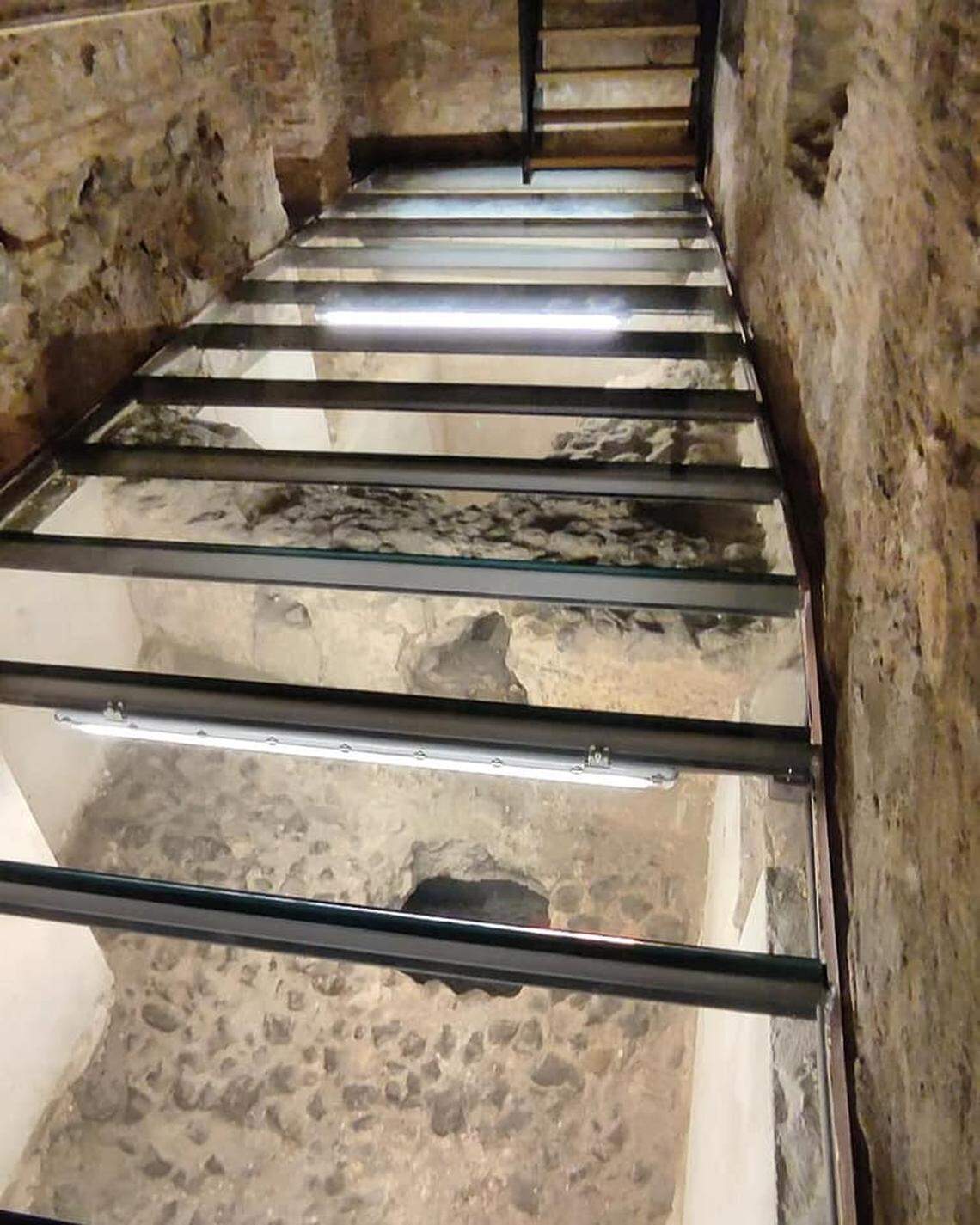 A glass walkway was installed over the Roman baths so visitors can see the ruins below.
