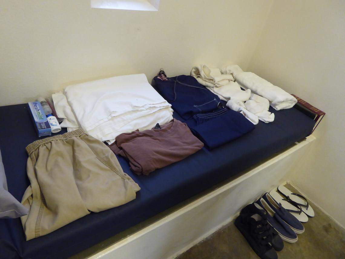 A display inside a cellblock at Guantánamo's maximum-security Camp 5 prison, which has about 70 empty cells, shows that navy blue is the new orange at the war-on-terror prison now. Captives who misbehave or of concern to management wore orange uniforms to distinguish them from those wearing white, brown or beige.