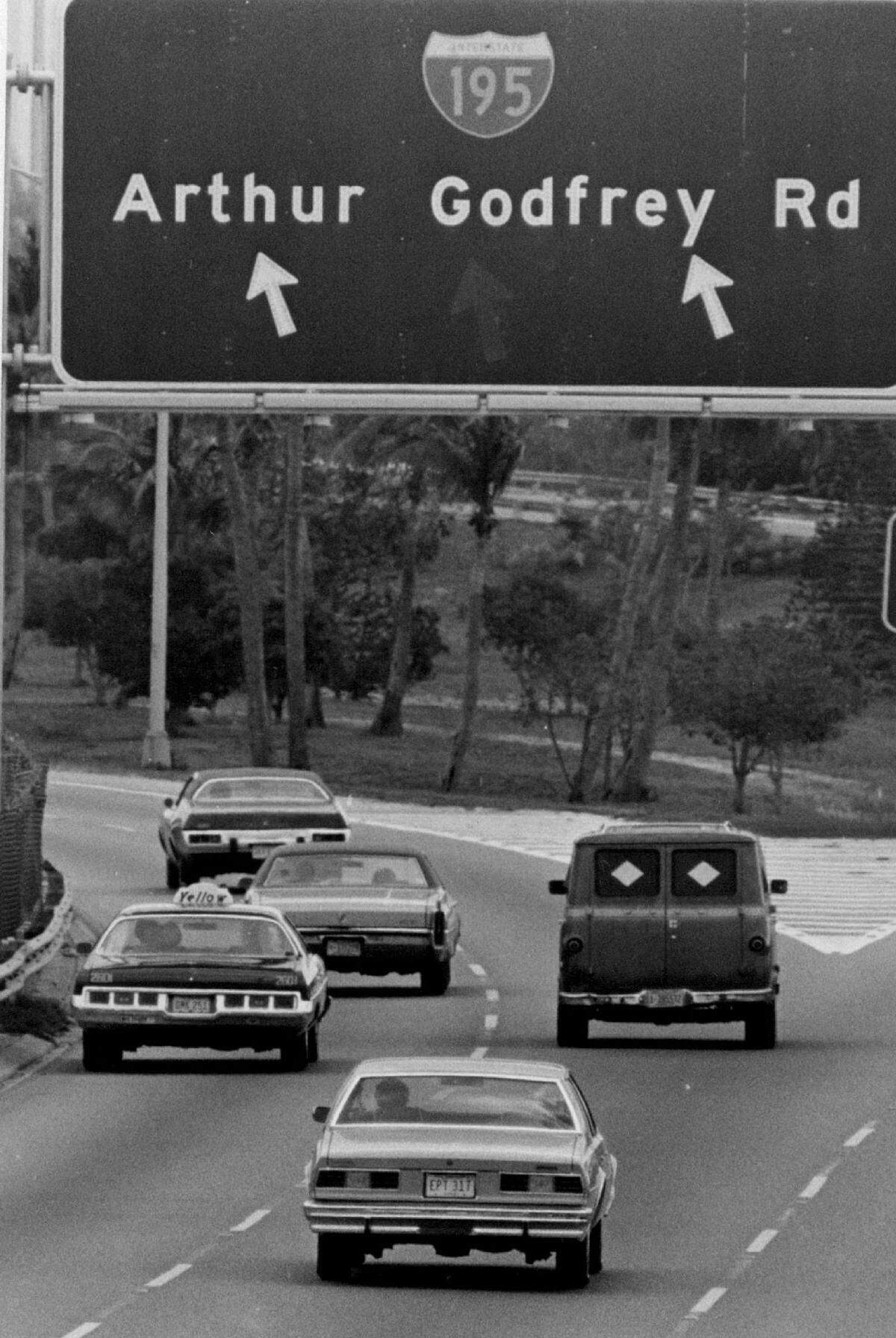 A sign points drivers to Arthur Godfrey Road.