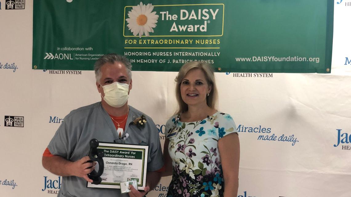 Earlier this year, Osnardo “Ozzie” Drago, left, received a Daisy Award for excellence in nursing from Caridad Nieves, chief nursing officer at Jackson. His special bond with a patient with severe autism inspired Jackson to seek UM-NSU CARD’s autism-friendly training designation.