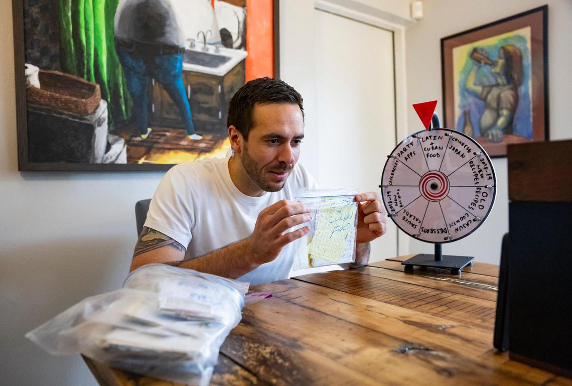 David Zarco, 36, records a video at his home in Hollywood for his TikTok account called “Dead Greg’s Recipes.” He will spin the wheel and select a recipe to prepare from Uncle Greg’s “cookbags.”