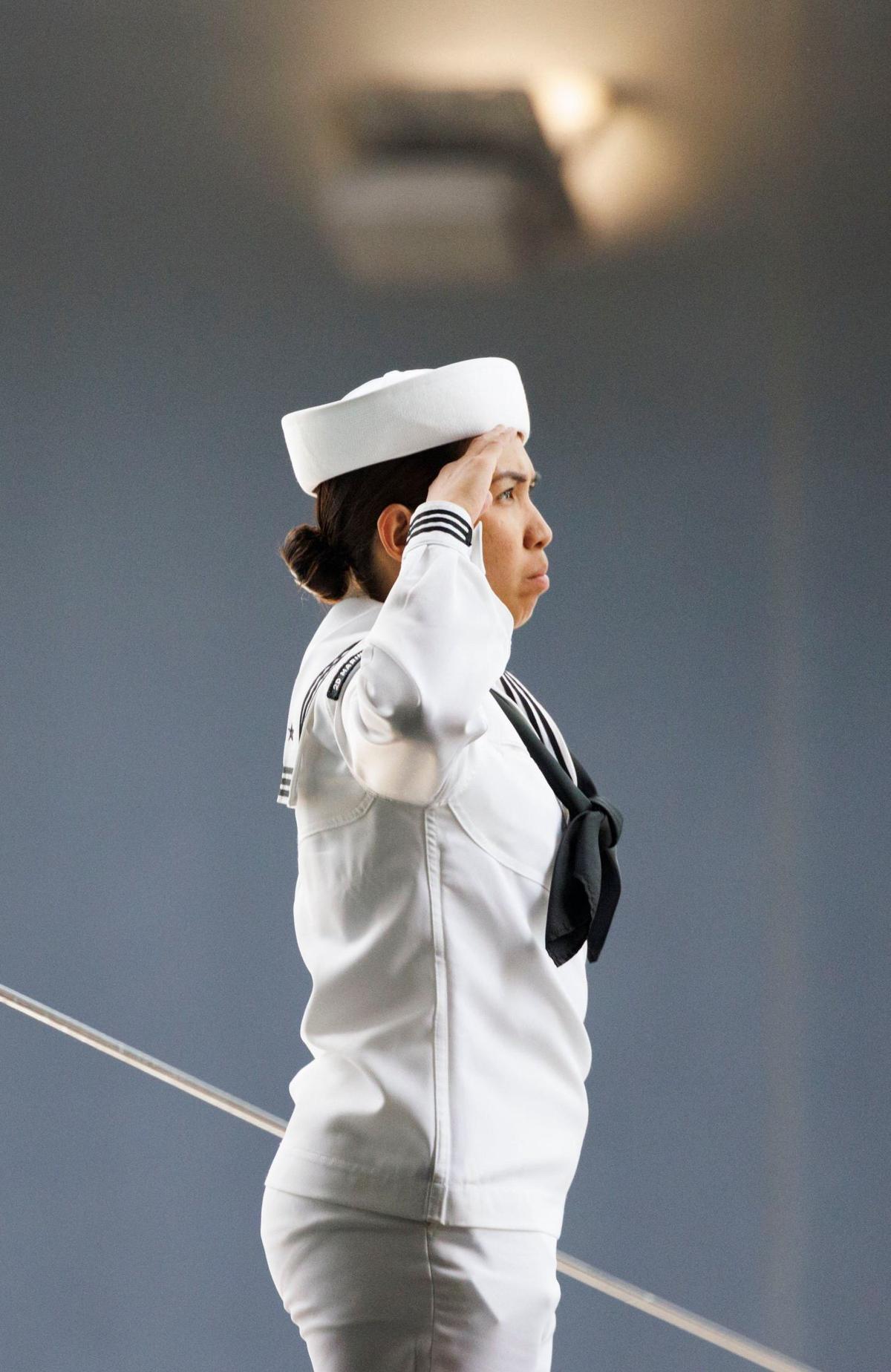 A naval sailor salutes as she leaves the USS Bataan during the opening day of Fleet Week on Monday, May 6, 2024, at Norwegian Cruise Lines Terminal in PortMiami.