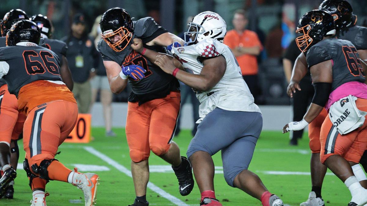 Cardinal Gibbons defensive tackle Ahmad Moten battles Cocoa Tigers offensive lineman Damian Seymour (77) during the Class 4A championship at DRV PNK Stadium, in Fort Lauderdale on Thursday, December 16, 2021.