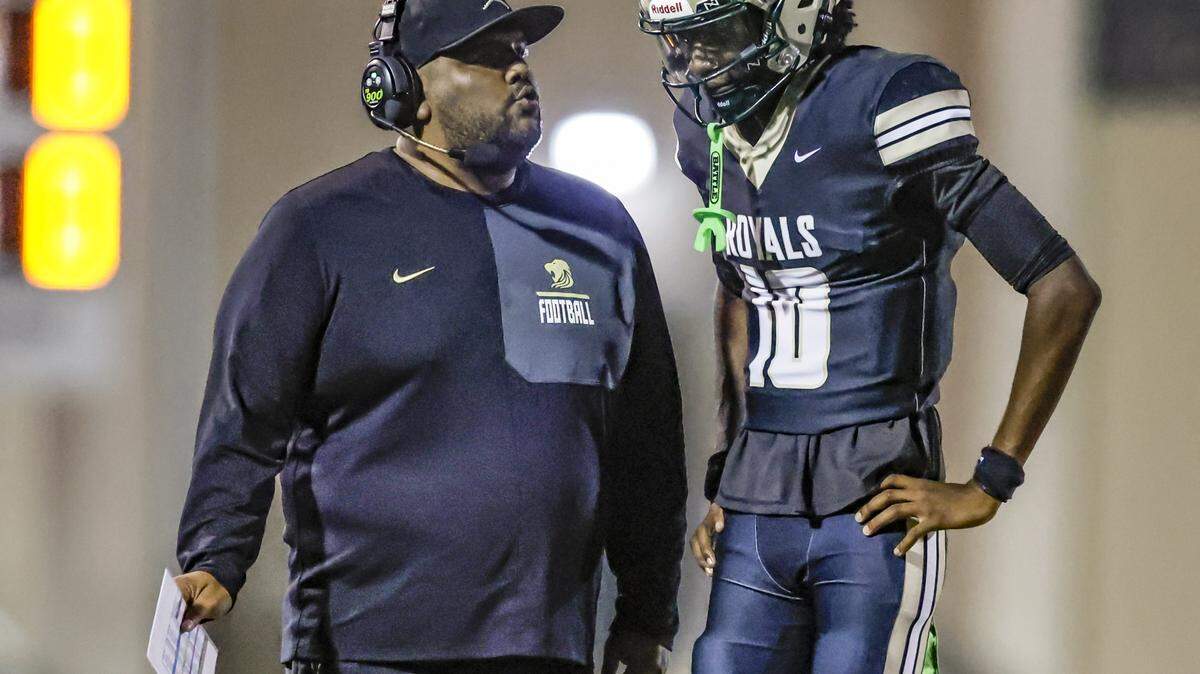 Immaculata-La Salle High School football head coach Helder Valle speaks with quarterback Nate Merrell Jr. (10) during a timeout during the game against Mater Academy at Immaculata-La Salle High School in Miami, FL, on Friday, October 24, 2025.