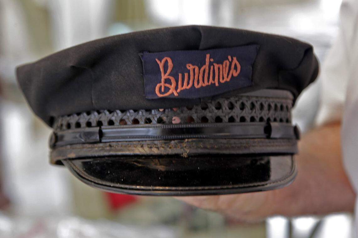 Historian Seth Bramson, one of the authors of Miami Stories who has been collecting Miami artifacts for over 50 years, holds a Burdine’s employee hat given to him by a reader after reading his article. The photo was taken at his home Tuesday, September 4, 2012.