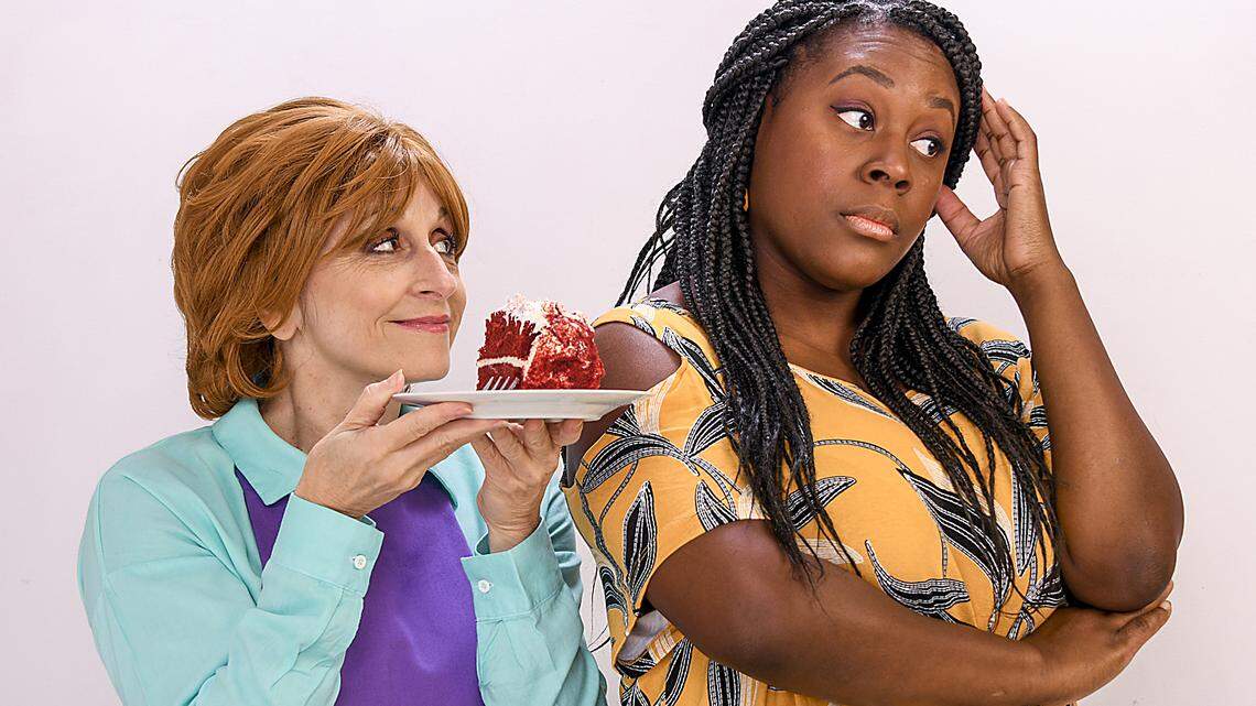 Irene Adjan as Della offers a slice of red velvet cake to a reluctant Stephon Duncan as Macy in City Theatre’s “The Cake” at the Arsht Center.