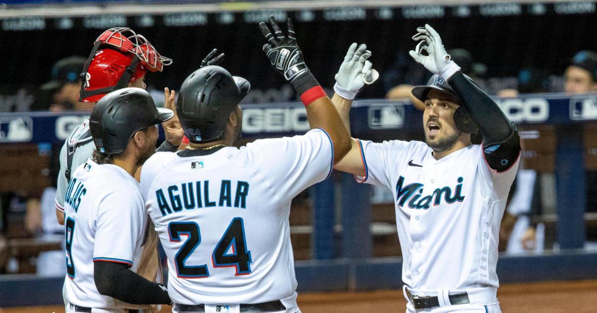 Miami Marlins player Adam Duvall (14) celebrates with teammates after hitting a two-run home run during the seventh inning of an MLB game against the Philadelphia Phillies at loanDepot park in the Little Havana neighborhood of Miami, Florida, on Monday, May 24, 2021. The Marlins defeated the Phillies 9-6.