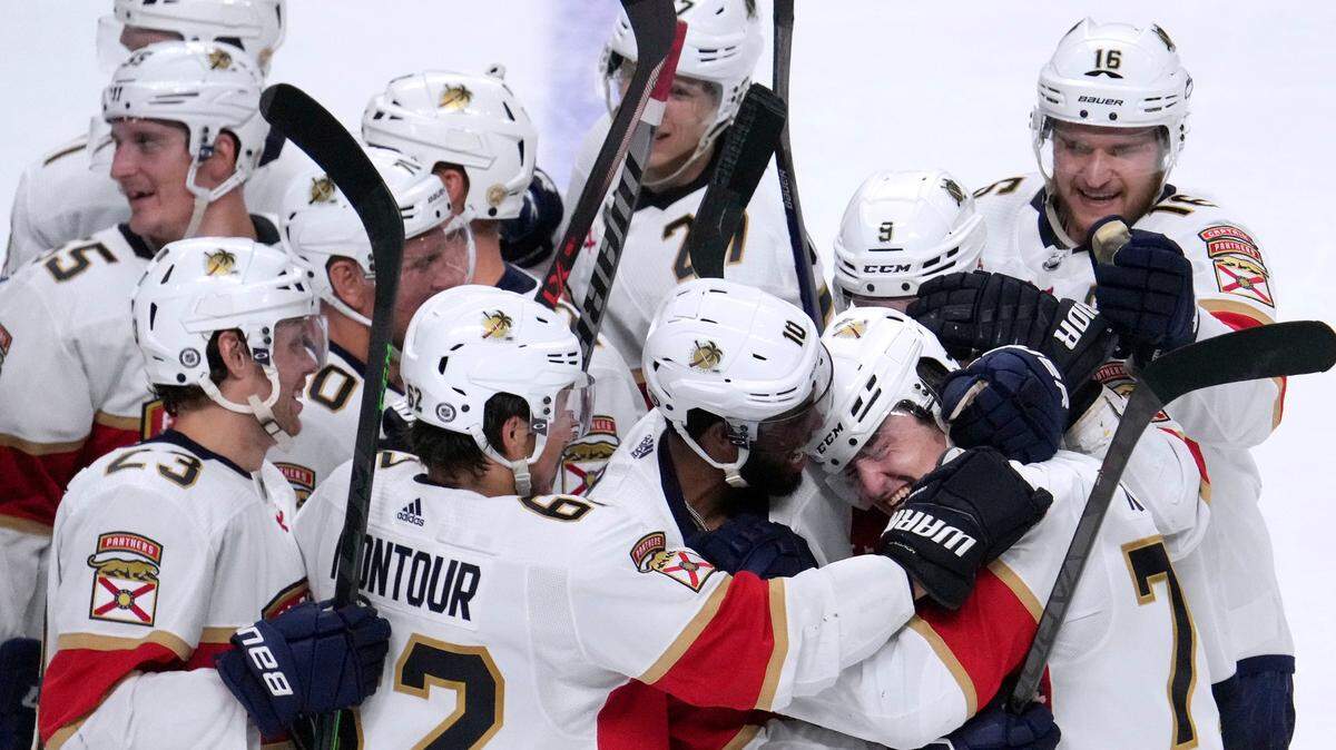 Florida Panthers center Frank Vatrano (77) celebrates with teammates after his overtime goal against San Jose Sharks in an NHL hockey game in San Jose, Calif., Tuesday, March 15, 2022. (AP Photo/Tony Avelar)