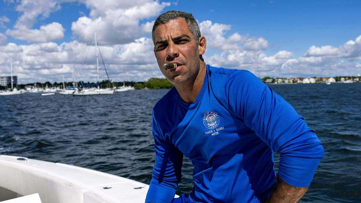 Miami Mayor Francis Suarez smokes a cigar as he sits port side of a boat during a fishing trip on Wednesday, October 15, 2025, in Miami, Fla.