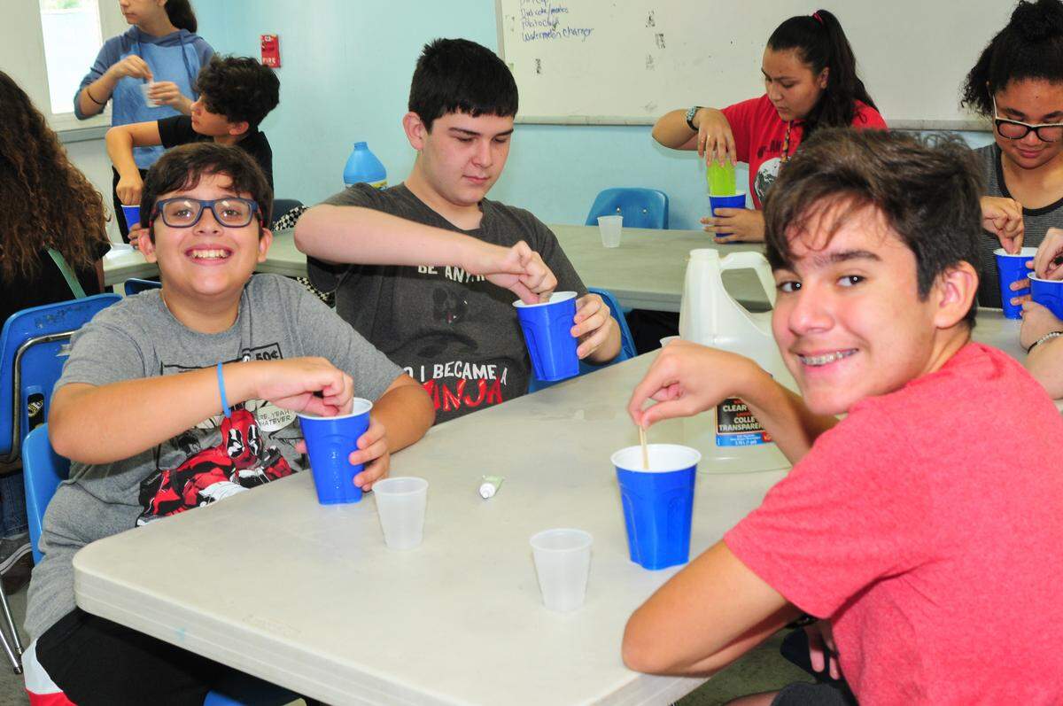 Campers learn how to make slime during science time at the Camp J Miami summer camp at the Alper JCC. The camp welcomes children and teens with special needs.
