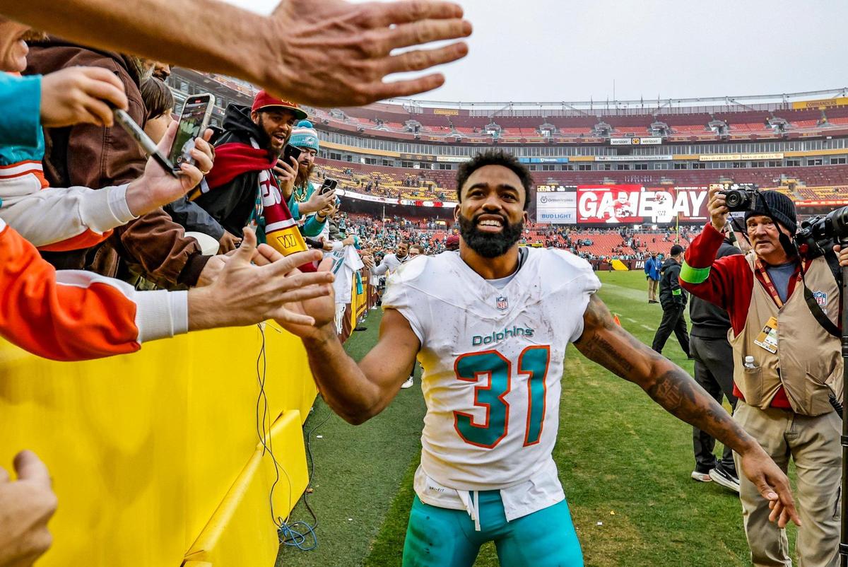 Miami Dolphins running back Raheem Mostert (31) celebrates the win against the Washington Commanders after the game at FedEx Field in Landover, Maryland on Sunday, December 3, 2023.