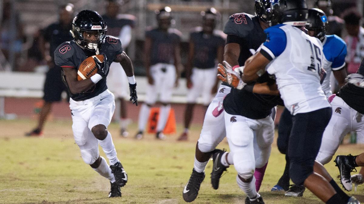 Southridge running back Courtney Reese scrambles to avoid a tackle during the first quarter of a high school football game against South Dade on Friday, Oct. 26, 2018 in Miami.