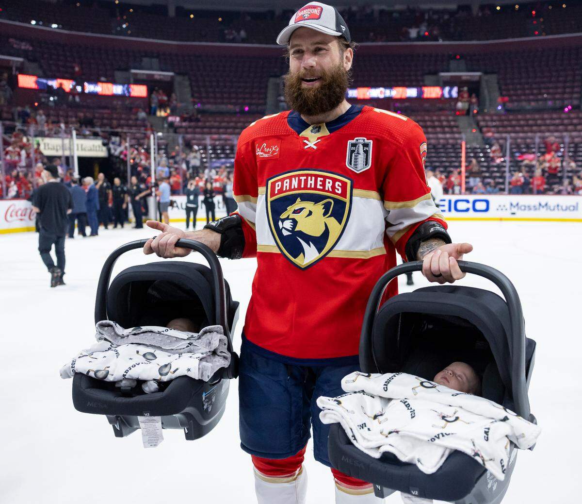 Florida Panthers left wing Jonah Gadjovich (12) holds his twins, Lion and Adalee, after defeating the Edmonton Oilers in Game 7 of the Stanley Cup Final at Amerant Bank Arena on Monday, June 24, 2024, in Sunrise, Fla.