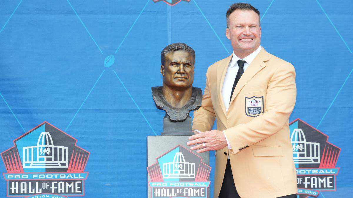 Aug 5, 2023; Canton, OH, USA; Miami Dolphins former linebacker Zach Thomas poses with his bust during the 2023 Pro Football Hall of Fame Enshrinement at Tom Benson Hall of Fame Stadium. Mandatory Credit: Kirby Lee-USA TODAY Sports
