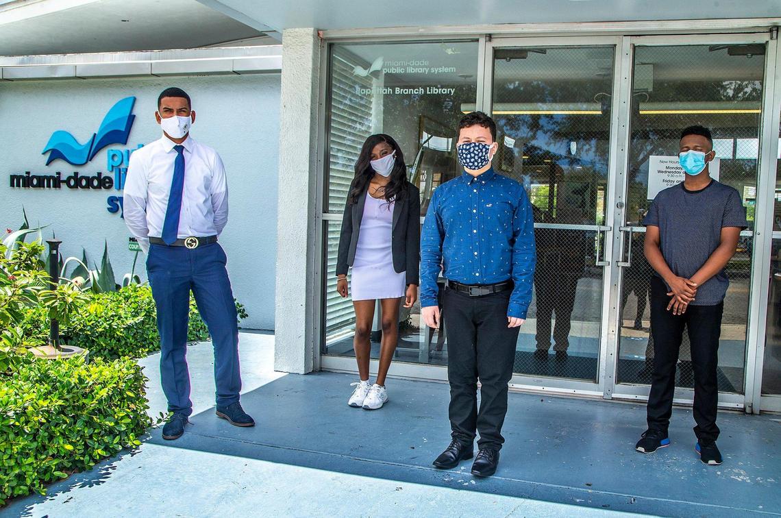 From left, Miami-Dade County students Fernando Salgado, Jayla Cannon, Jose Arriaza and Elianyer Navarro stand in front of the Allapattah Branch Library on Tuesday, June 8, 2021, to protest the planned closing of the branch. The City of Miami is ending the county library branch’s lease at its current location, alarming neighbors at the loss of the community hub. A group that includes students at a nearby high school are organizing to save the library.