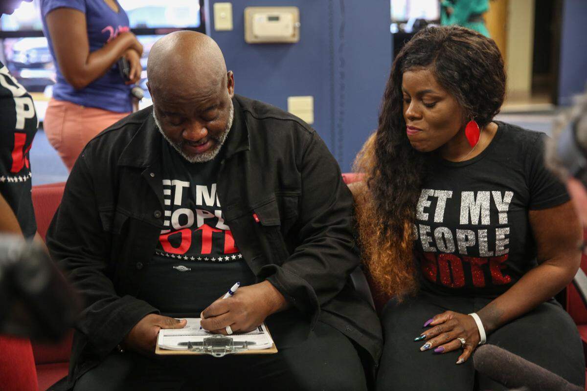 Desmond Meade registered to vote, his wife Sheena Meade beside him, at the Orange County Supervisor of Elections office in January 2018.