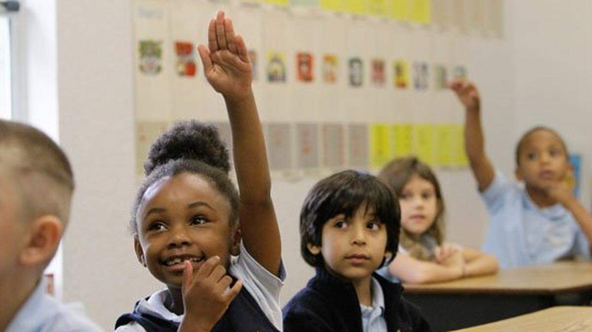 In this 2014 file photo, Rheeann Lucceus raises her hand with the answer beside classmate Christopher Mejia while doing addition with money in Erika Choi’s first grade class at Classical Prep, one of Pasco County’s newest charter schools. It focuses on a “classical” education that requires each student to take a core, liberal arts curriculum.