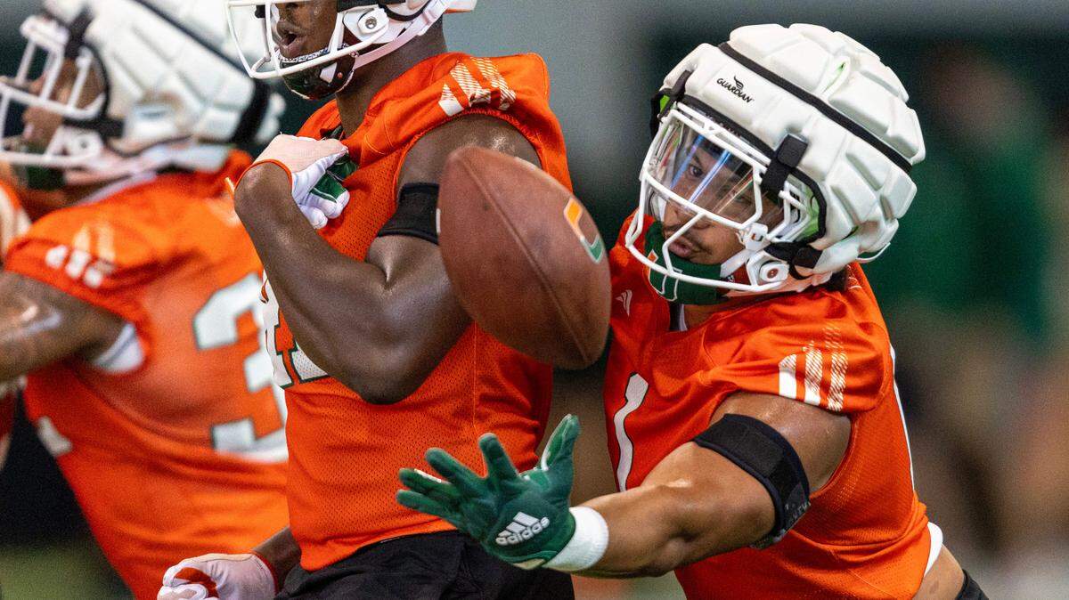 Miami Hurricanes linebacker Francisco Mauigoa (1) strips the ball as he runs through drills during practice at the Carol Soffer Indoor Practice Facility on Thursday, August 1, 2024, in Coral Gables, Fla.