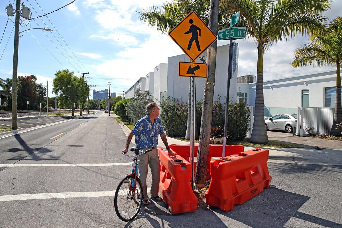 Elvis Cruz rides his bike to the odd intersection at Northeast Fourth Avenue and Northeast 55th Terrace in Little Haiti. He’s criticized a city street improvement project that created hazardous obstacles and “nonsensical” parking in a neighborhood on its way to gentrification.