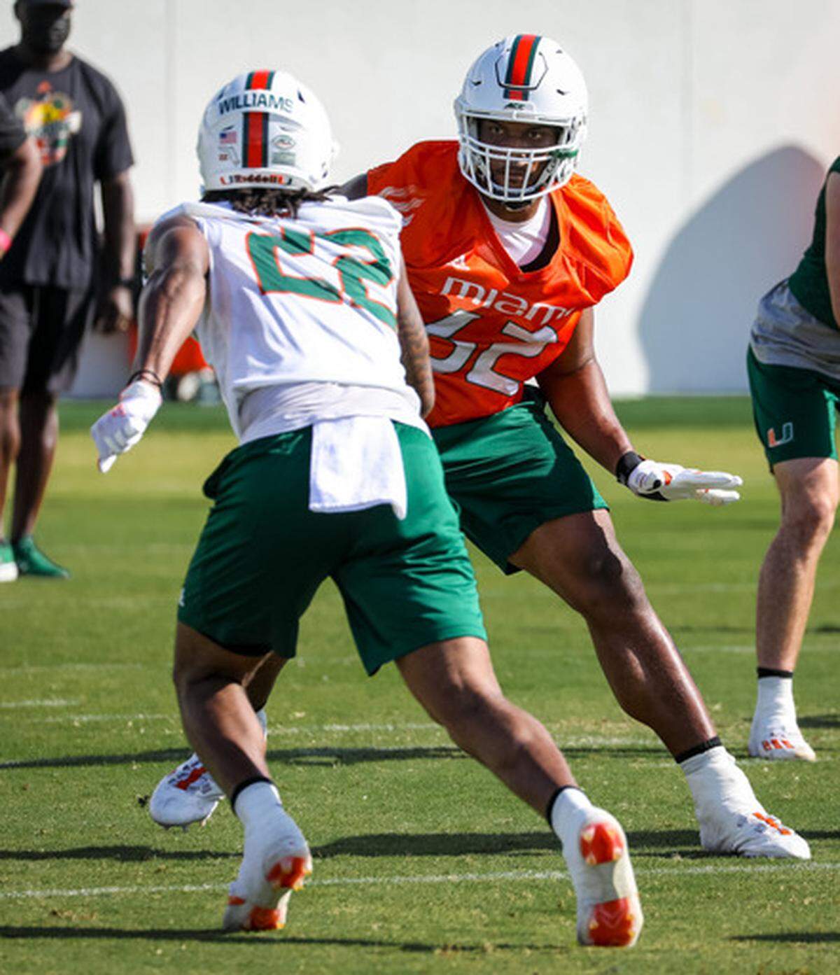 Right tackle Jarrid Williams (orange jersey) goes against defensive end Cameron Williams during spring practice on March 16, 2021.