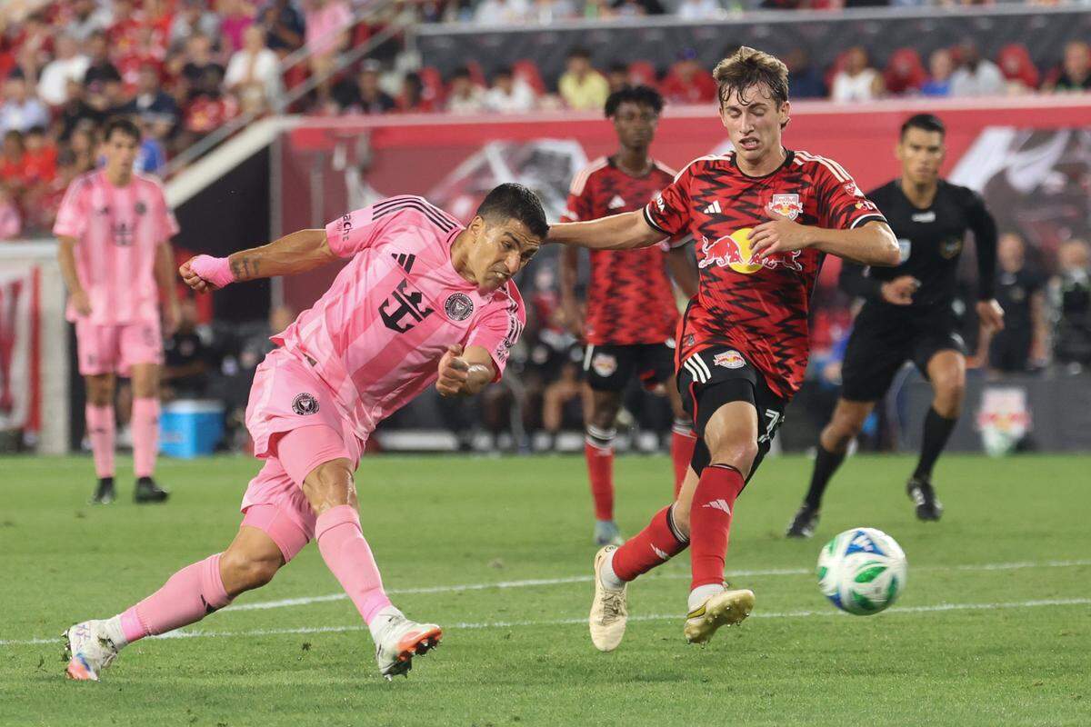 Jul 19, 2025; Harrison, New Jersey, USA; Inter Miami CF forward Luis Suarez (9) kicks the ball as New York Red Bulls midfielder Daniel Edelman (75) defends during the second half at Sports Illustrated Stadium.