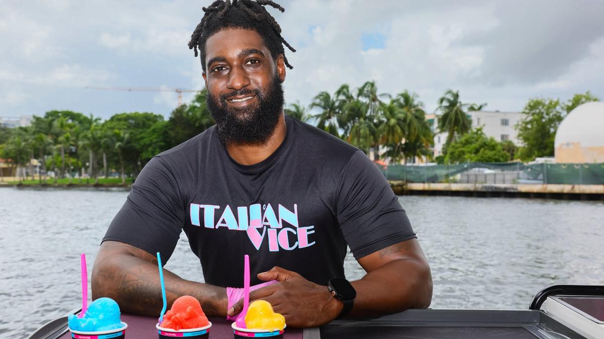 Aamir Taylor, owner of Italian Vice, a Miami-based water ice company, is photographed with cups of water ice flavors Nipsey Blue, Saweetie Strawberry and Mango Meek by the Miami River in downtown Miami on Friday, Oct. 11, 2024. Taylor named the flavors after hip-hop artists.