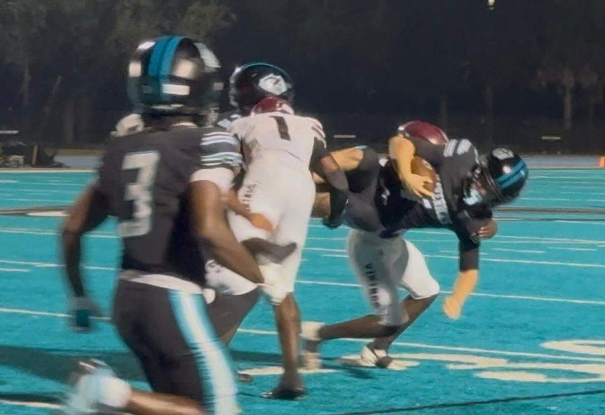 Archbishop McCarthy quarterback Robert Kerns (right) dives for extra yards during Friday’s Region 4-4A semifinal playoff against Miami Norland.