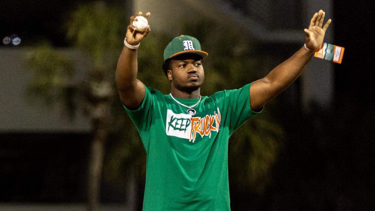 UM star defensive end Rueben Bain threw out the first pitch Friday in Miami baseball’s opening game against the Florida Gators at Mark Light Field on March 1, 2024.