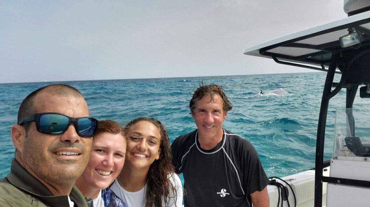 Monroe County Sheriff’s Office Deputy Nelson Sanchez poses with three people he rescued from the water Tuesday, June 15, 2021, after their boat capsized off Duck Key in the Florida Keys.