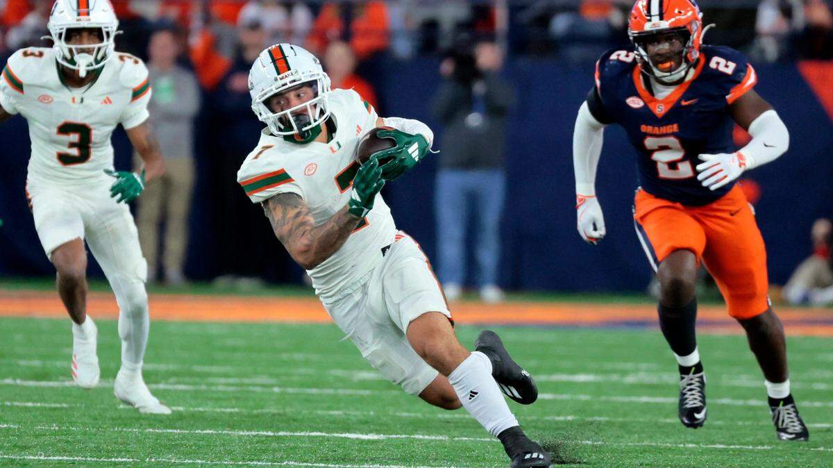 Miami Hurricanes wide receiver Xavier Restrepo (7) on a first down pass reception against the Syracuse Orange in the second half of their NCAA football game in the JMA Wireless Dome at Syracuse University, Syracuse, New York on Saturday, November 30, 2024.