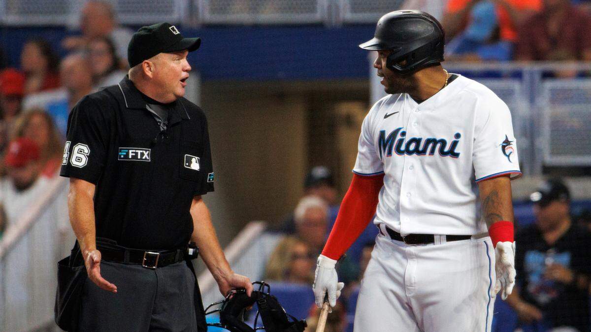 Miami Marlins designated hitter Jesus Aguilar (99) talks with home plate umpire Ron Kulpa during the second inning of a baseball game against the Philadelphia Phillies at LoanDepot Park on Sunday, July 17, 2022 in Miami, Florida.