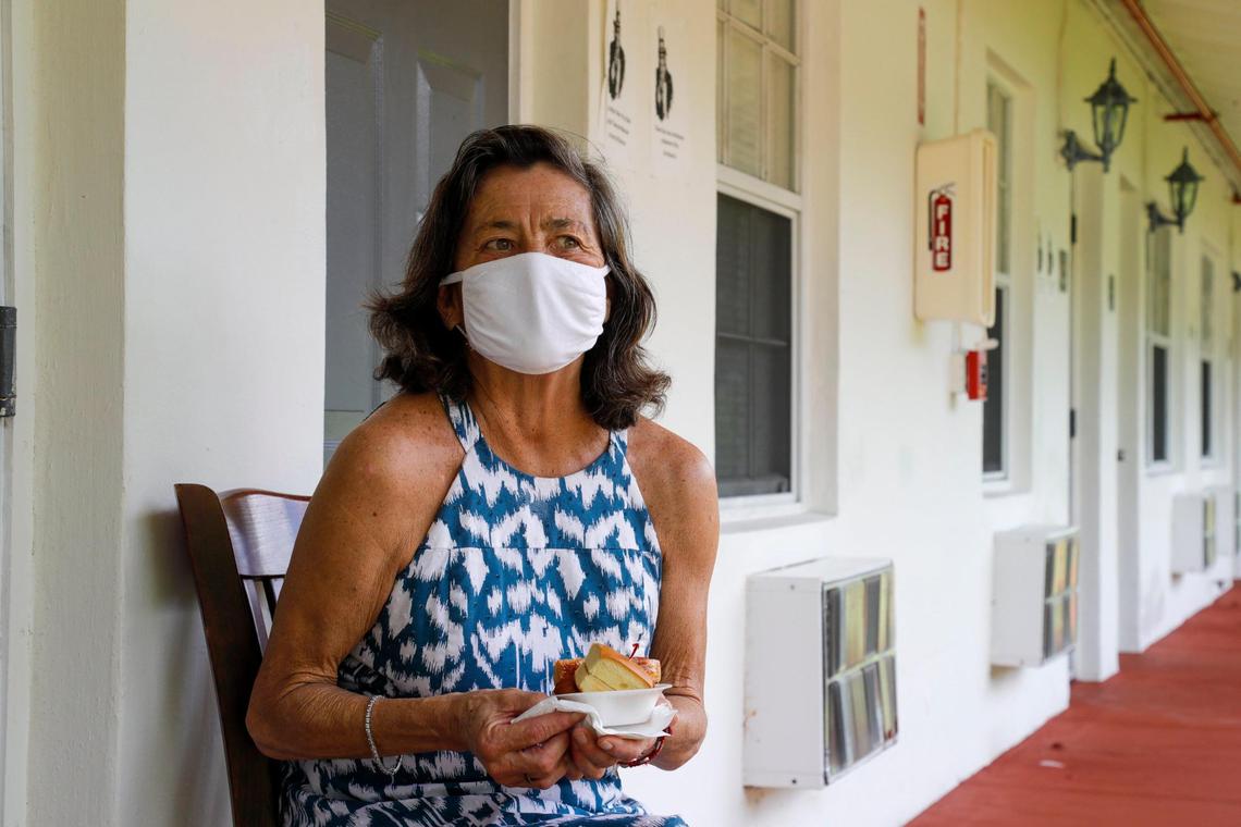 Virginia “Jeannie” Mayhall, 65, holds her afternoon snack in the hallway outside her bedroom door at Mia Casa, the former assisted living center in North Miami that the Miami-Dade County Homeless Trust is leasing to house senior citizens in Miami who are homeless.