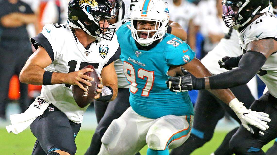 Miami Dolphins defensive tackle Christian Wilkins (97) eyes Jacksonville Jaguars quarterback Gardner Minshew (15) in the second quarter at Hard Rock Stadium in Miami Gardens, Florida, Thursday, August, 22, 2019. 