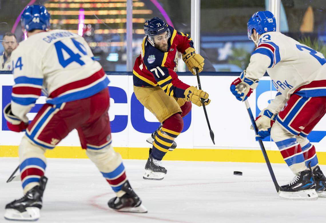 Florida Panthers center Luke Kunin (71) shoots the puck as New York Rangers defenseman Adam Fox (23) defends in the third period of their Winter Classic outdoor hockey game at loanDepot park on Friday, Jan. 2, 2026, in Miami, Fla.