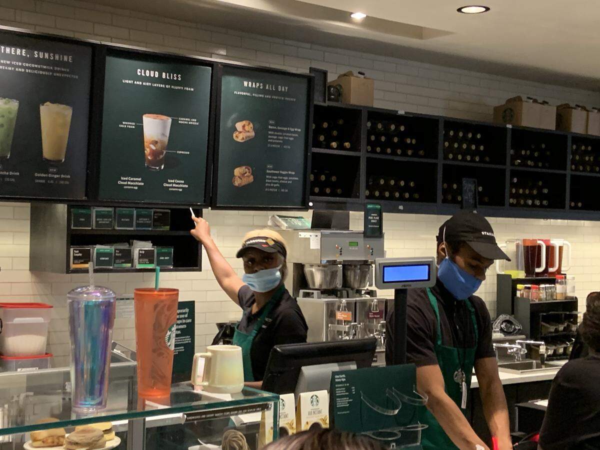 Photos taken around 12:30 p.m. Friday show some Starbucks employees wearing a mask that only partially covers their face. This Starbucks is located on the Jackson Memorial Hospital campus.