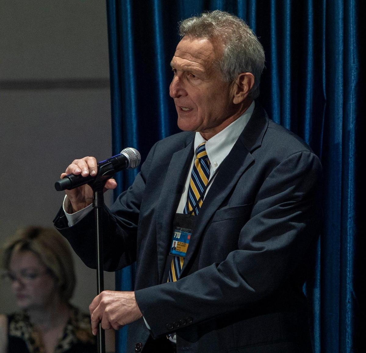 FIU faculty member Robert Sackstein asks a question from the panel during a community listening session on the presidential search held at the Graham University Center, Modesto Maidique Campus.