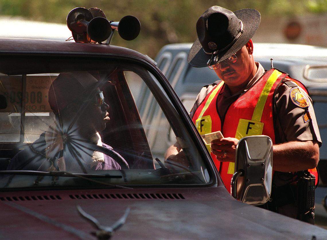 A driver with a busted windshield gets a warning from an FHP trooper.