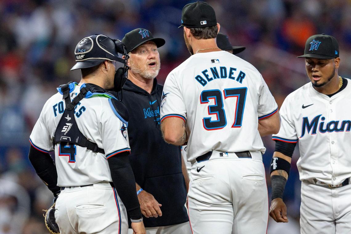 Miami Marlins pitching coach Mel Stottlemyre Jr. speaks to relief pitcher Anthony Bender (37) on the mound during the seventh inning of an MLB game against the Pittsburgh Pirates at LoanDepot Park in Miami, Florida, on Thursday, March 28, 2024.