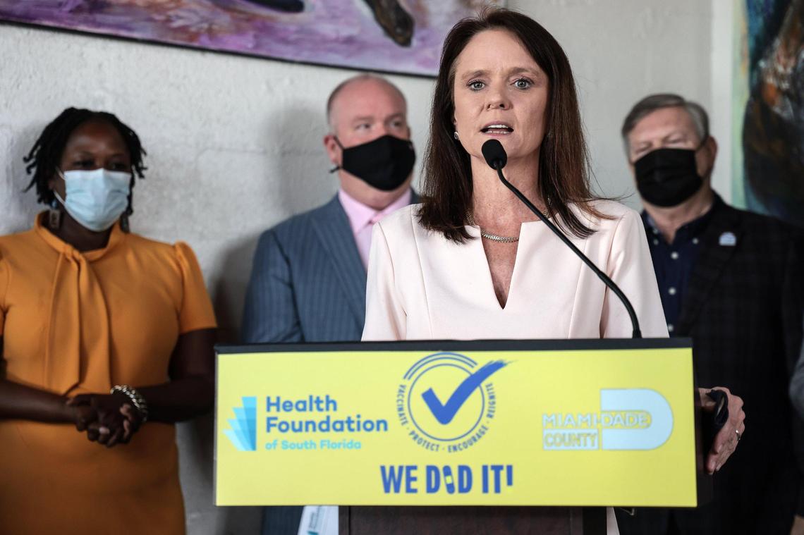 Loreen Chant, president and CEO of the Health Foundation of South Florida, center, announces an initiative to encourage COVID-19 vaccinations at Dukunoo Jamaican Kitchen in Wynwood. on Oct. 21, 2021.