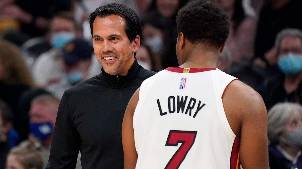 Miami Heat coach Erik Spoelstra smiles next to guard Kyle Lowry (7) as the Heat led the Phoenix Suns during the second half of an NBA basketball game Saturday, Jan. 8, 2022, in Phoenix.