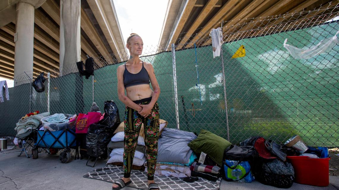 Bambi Nicole Kuttkuhn, who is homeless, stands on the shortened sidewalk underneath the I-95 expressway off Northwest 11th street between Northwest Fifth and Third Avenue in Miami, Florida, on Monday, September 20, 2021.