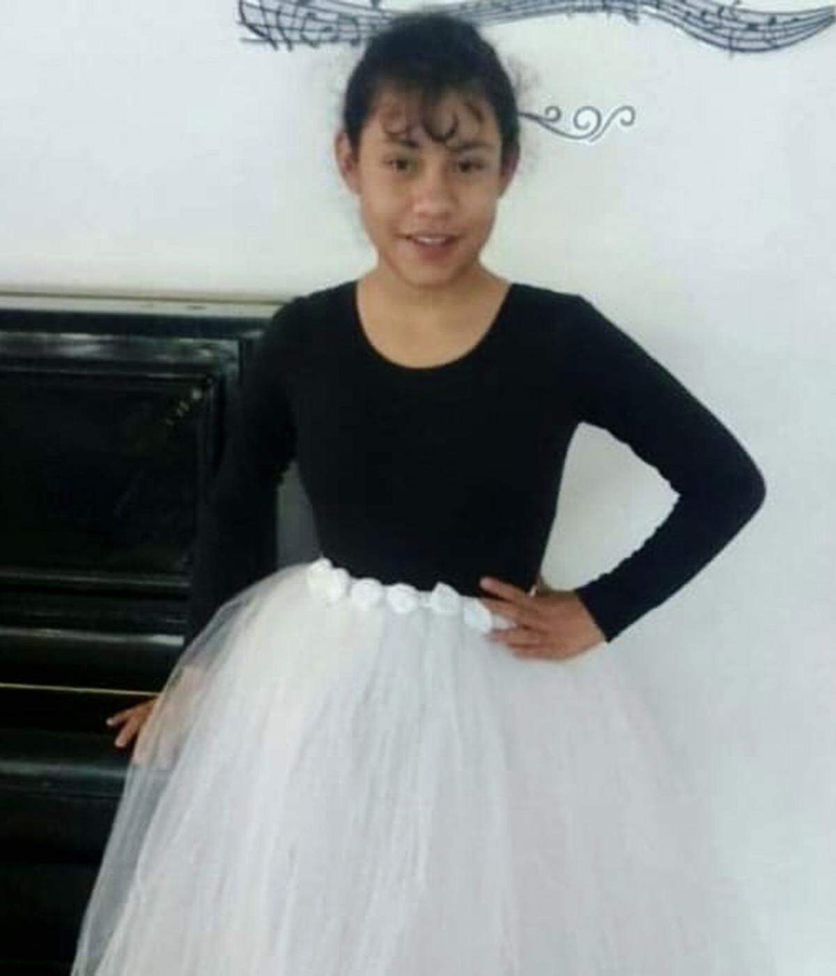Michaela posing in her dance uniform when she was younger.