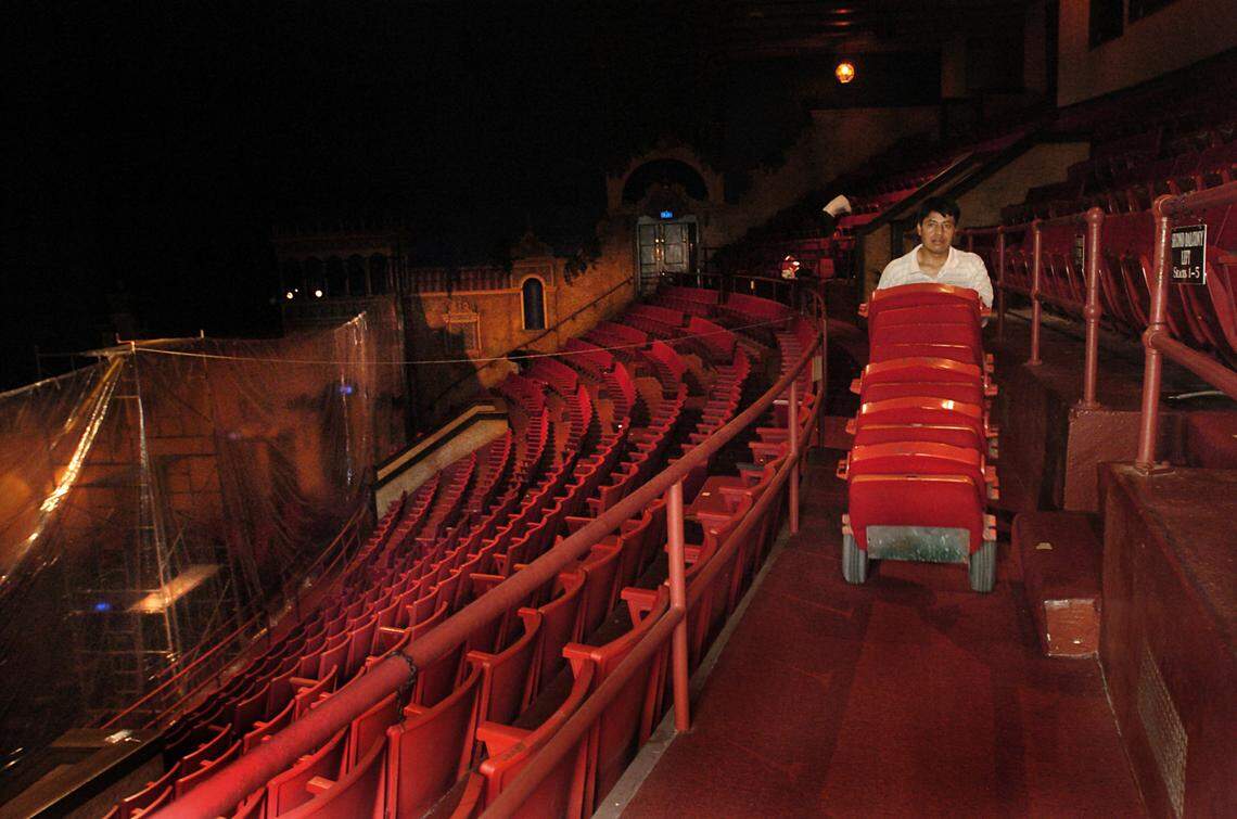 July 7, 2007 – Workers begin removing approximately 878 seats from the Gusman Center for the Performing Arts at 174 E. Flagler Street. Here, worker Julio Elias carts seat cushions to the fire escape, where they are tossed into a dumpster in the alley below.