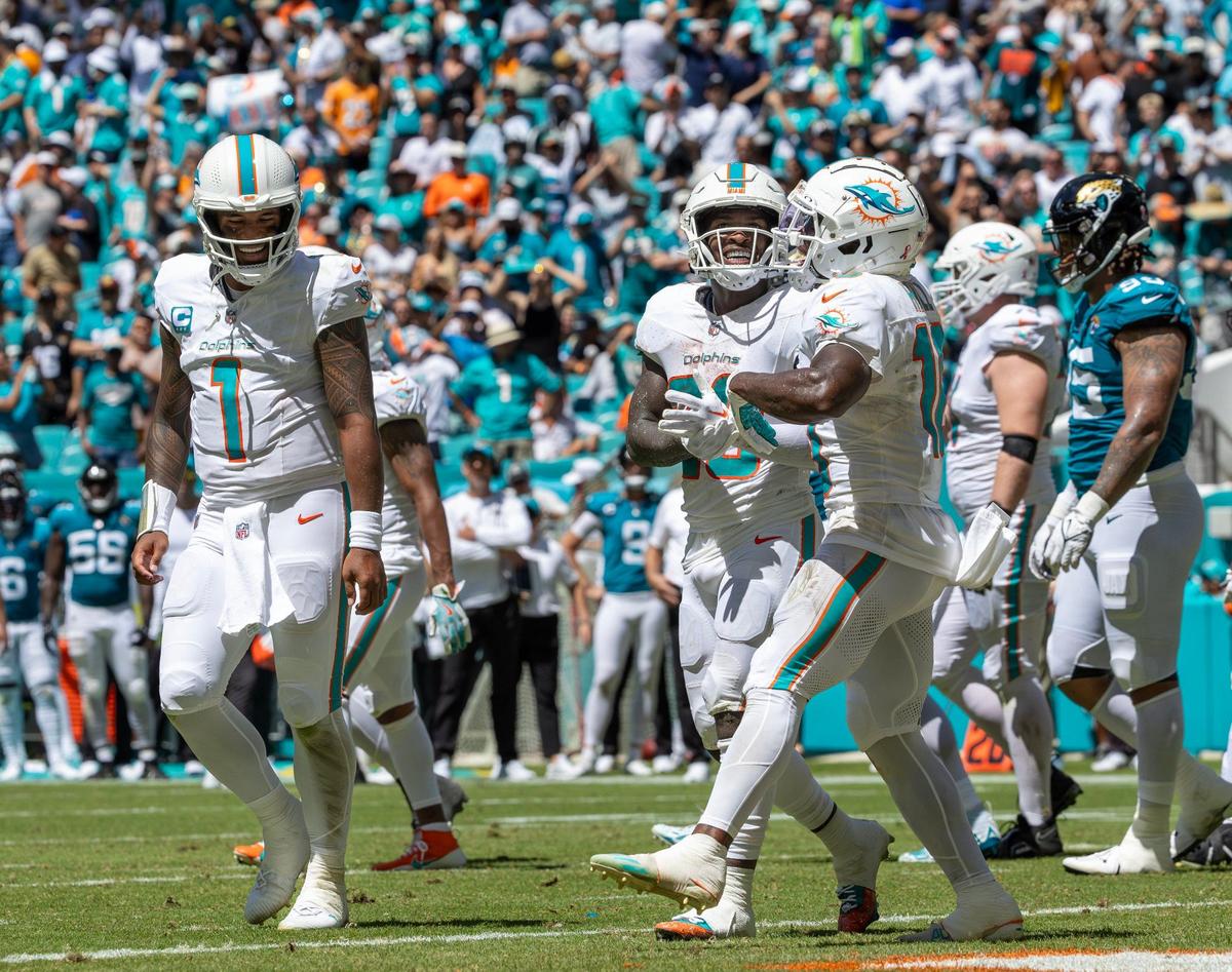 Miami Dolphins running back De’Von Achane (28) celebrates with Dolphins quarterback Tua Tagovailoa (1) and Dolphins wide receiver Tyreek Hill (10) after scorings a touchdown during the first half of an NFL football game against the Jacksonville Jaguars at Hard Rock Stadium on Sunday, Sep. 8, 2024, in Miami Gardens, Fl.