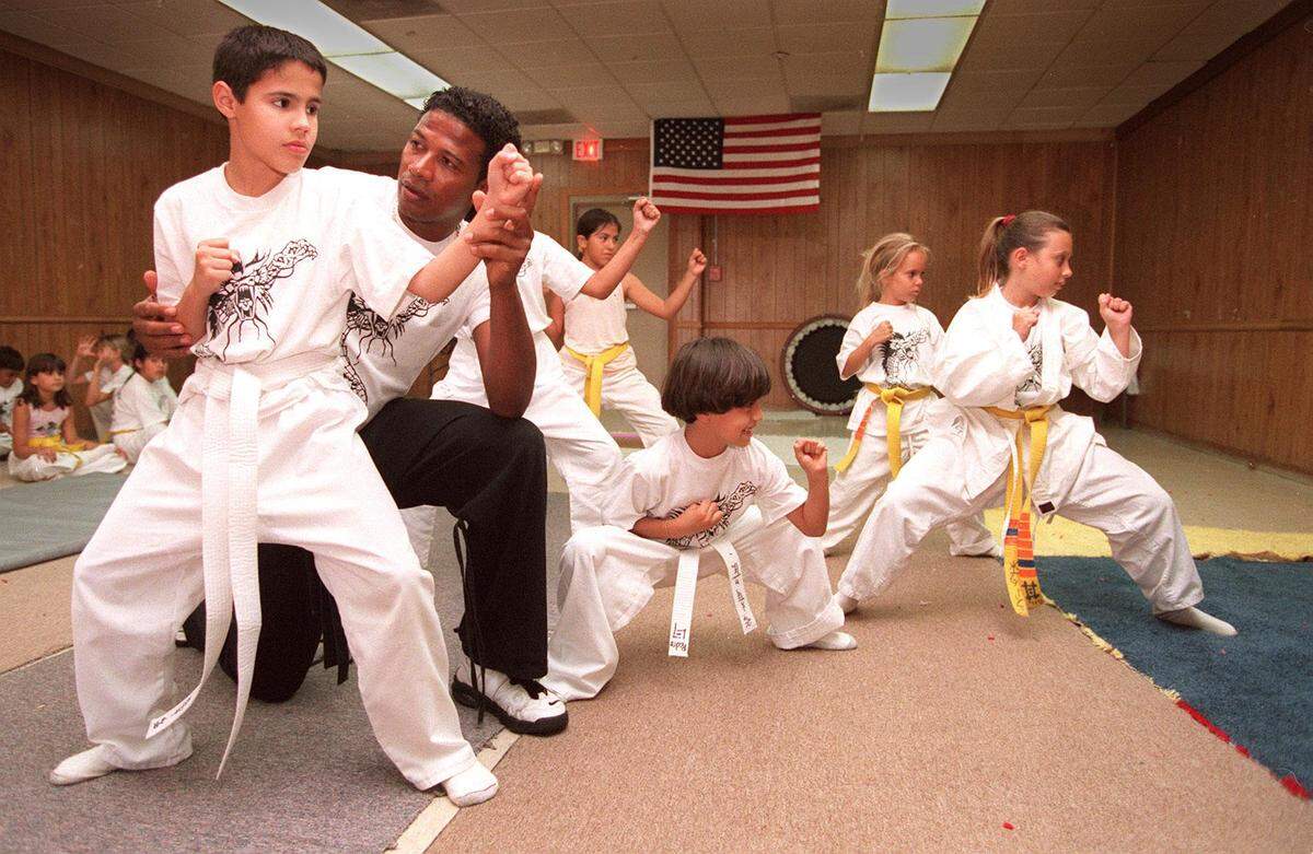 Mark Davis helps Jorge Mendez with his karate stance during lessons in 1998 at the Surfside Community Center.
