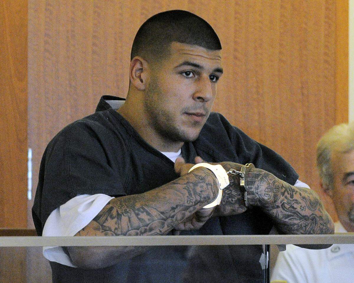 Former New England Patriots football tight end Aaron Hernandez stands during a bail hearing in Fall River Superior Court in this June 27, 2013 file photo taken in Fall River, Mass.