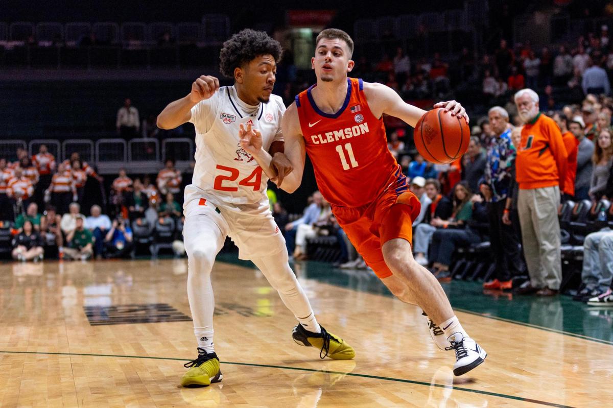University of Clemson guard Joseph Girard III (11) drives on Miami Hurricanes guard Nijel Pack (24) during the first half of an NCAA basketball game at the Watsco Center in Coral Gables, Florida, on Wednesday, January 3, 2024.
