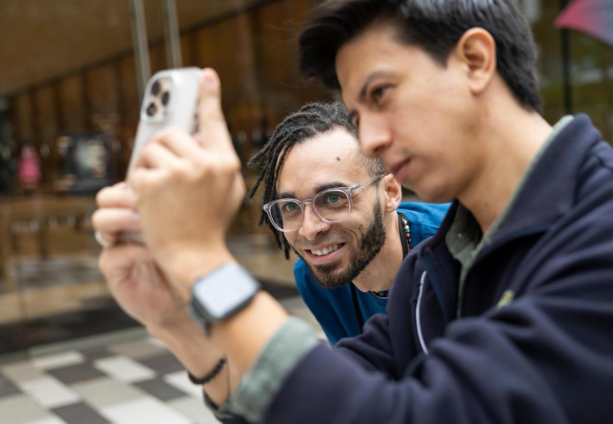 Photographer Erick Quituizaca, right, and Jared Molina, left, an Apple creative pro, give a ‘Today at Apple’ session on improving iPhone photography during a media preview of the new Apple Miami Worldcenter store on Wednesday, Jan. 22, 2025, in downtown Miami, Fla. Apple is set to open its newest store in downtown Miami on Friday, featuring a dedicated pickup area and a biophilic garden.